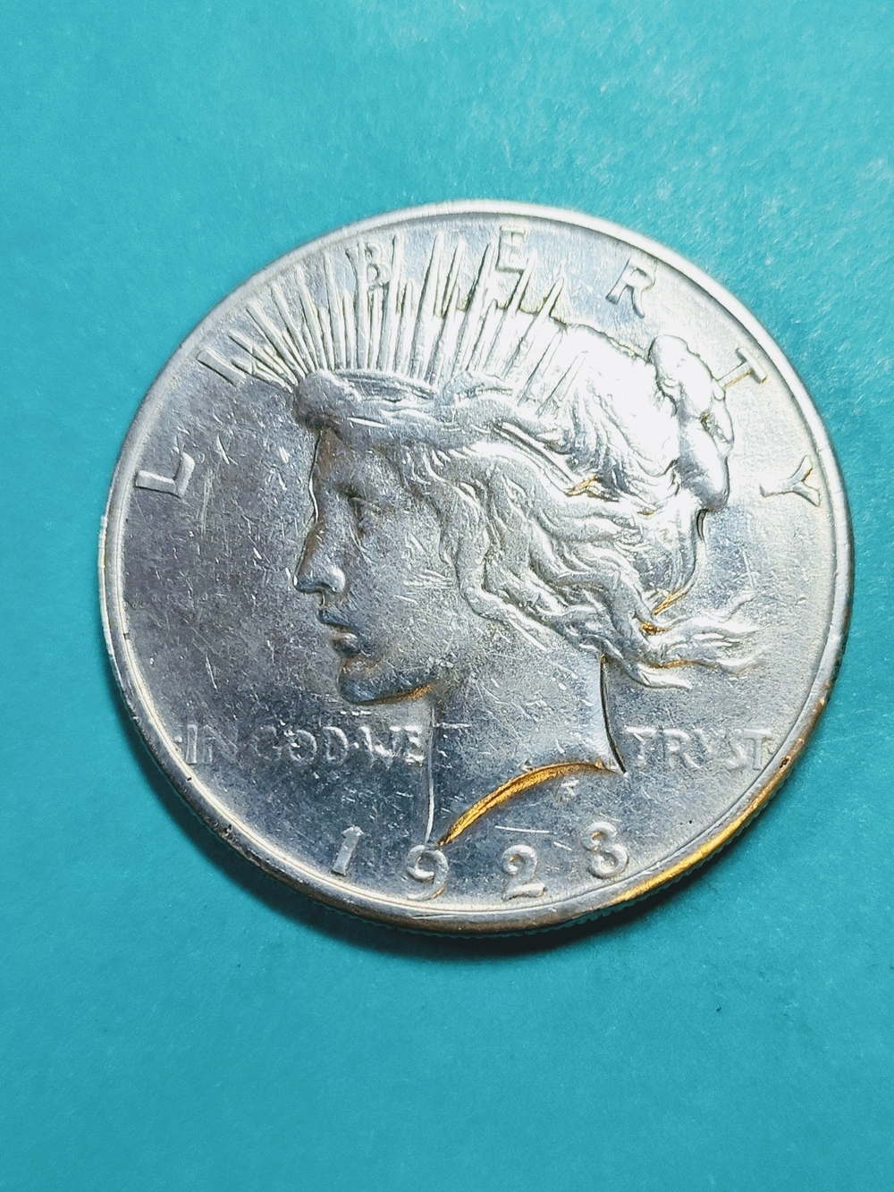 1923 90% Silver Peace Silver Dollar In Good Circulated Condition.